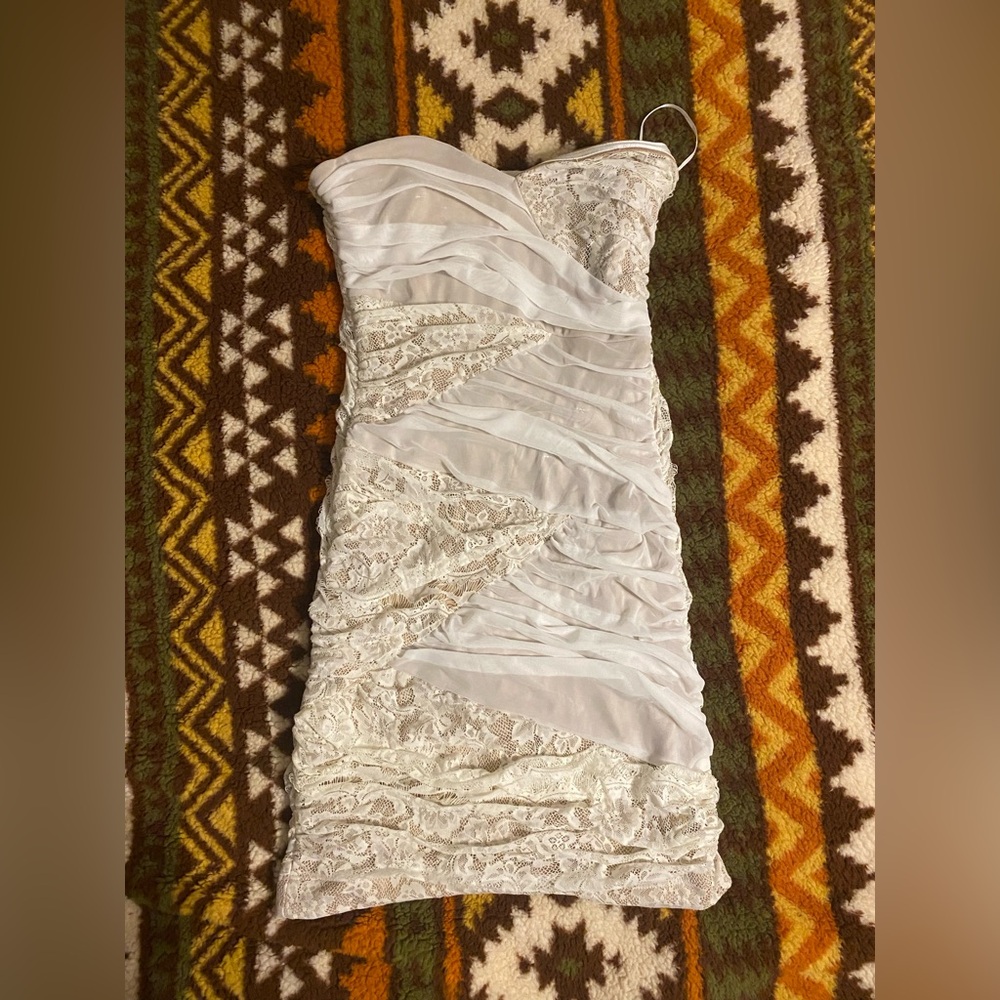 Bridal party bachelorette White Lace Dress blush skin color background.